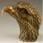 Golden brass eagle sculpture decorative with intricately detailed feathers and sharp curved beak in bronze material