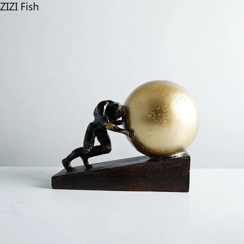 Black metal figure statue of a man pushing a golden sphere on a dark wooden base modern style home decor