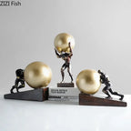 Bronze-colored fitness figure statue with muscular men pushing golden spheres on wooden bases modern style home decor