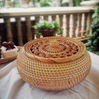 Woven basket with a lid on a table outdoors