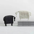 White resin sheep figurine with textured knit pattern complementing an elegant ceramic horse figurine display