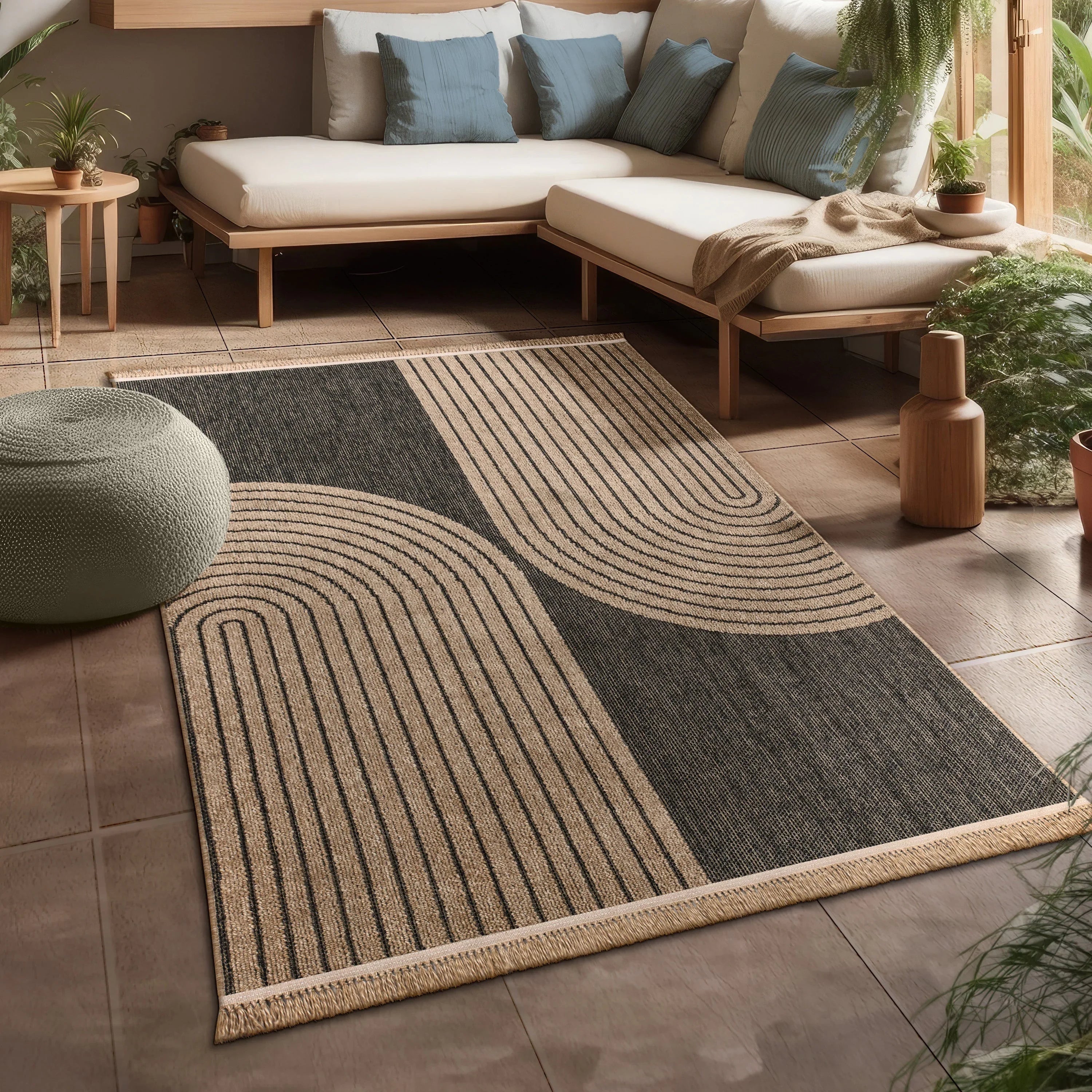 Modern beige and black indoor outdoor rug with arched line patterns in a sunlit patio setting.