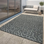 Dark grey Marrakesh Moroccan ornament rug on a modern patio with outdoor furniture.