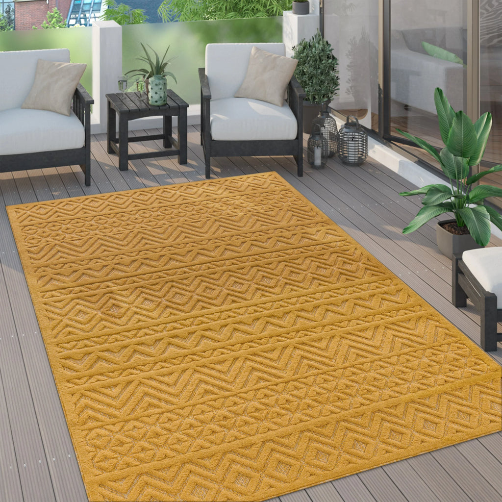 Yellow Livorno boho indoor outdoor rug with a geometric high-low pattern on a modern grey wood patio.