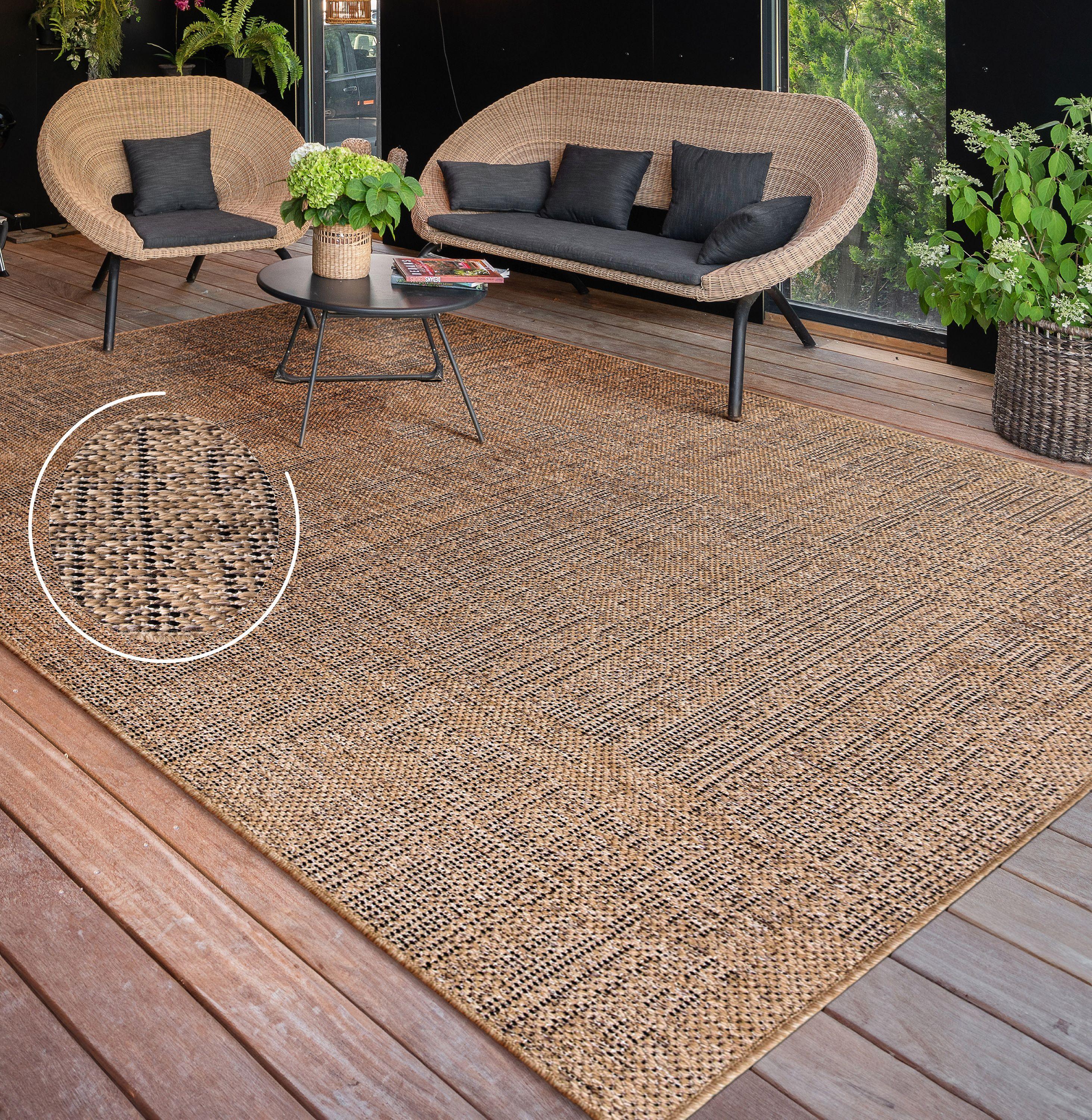 Rico mottled pattern indoor and outdoor rug featuring a brown and black weave on a wooden deck.
