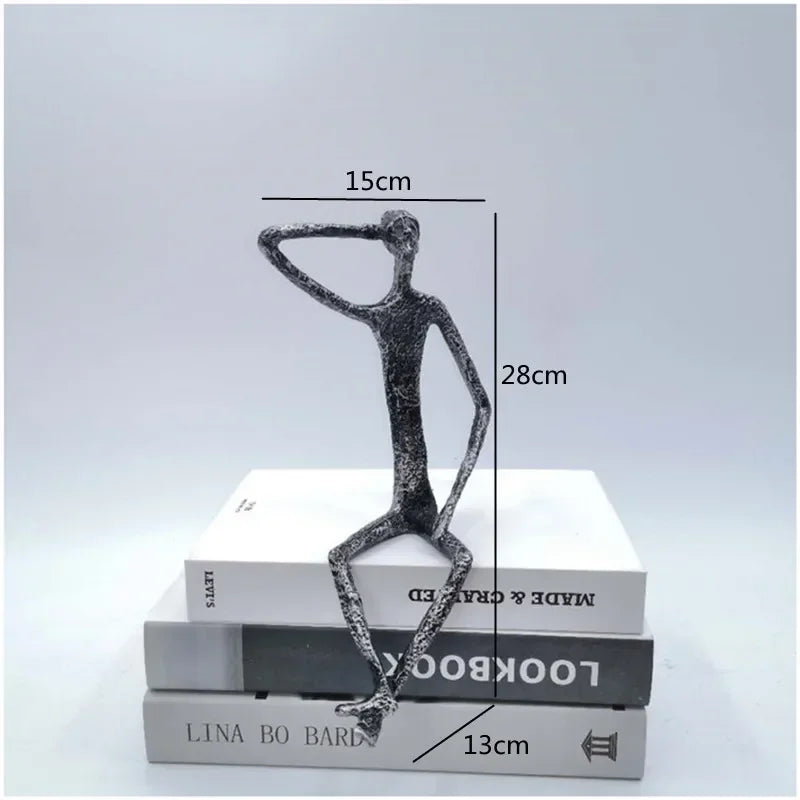 A sleek large abstract sitting human sculpture in modern metal with one arm raised to its head