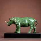 Luxury green rhinoceros statue with a polished marbled finish and gold-colored hooves for home and office decor