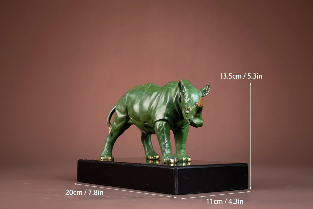 Luxury green rhinoceros statue with gold horns and feet standing on a black base for home and office decor
