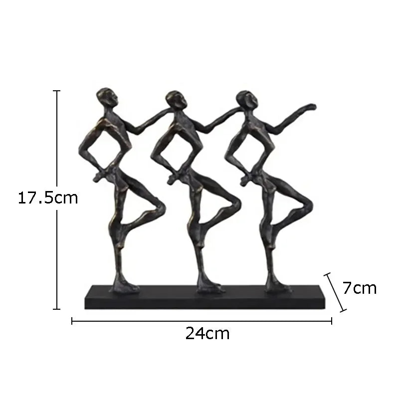 Black metallic metal sculpture of three stylized dancers on a rectangular base ideal for a unique metal desk display