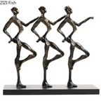 Bronze-colored metal sculpture of three stylized dancers on black base for unique metal desk decor