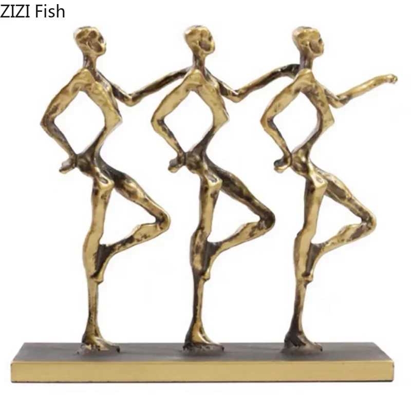 Metal sculpture featuring three golden stylized dancing figures on a matching gold base for a unique metal desk display