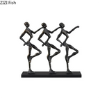 Black metallic unique metal sculpture of three stylized dancers on a rectangular base for unique metal desk decor