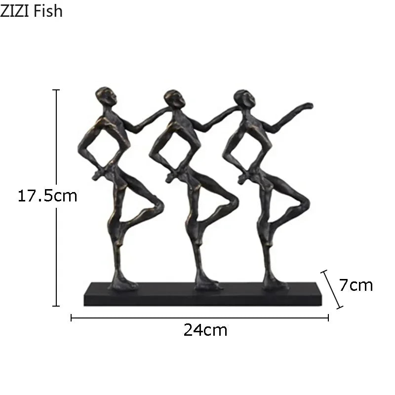 Black metallic metal sculpture of three stylized dancers on a rectangular base for a unique metal desk accessory