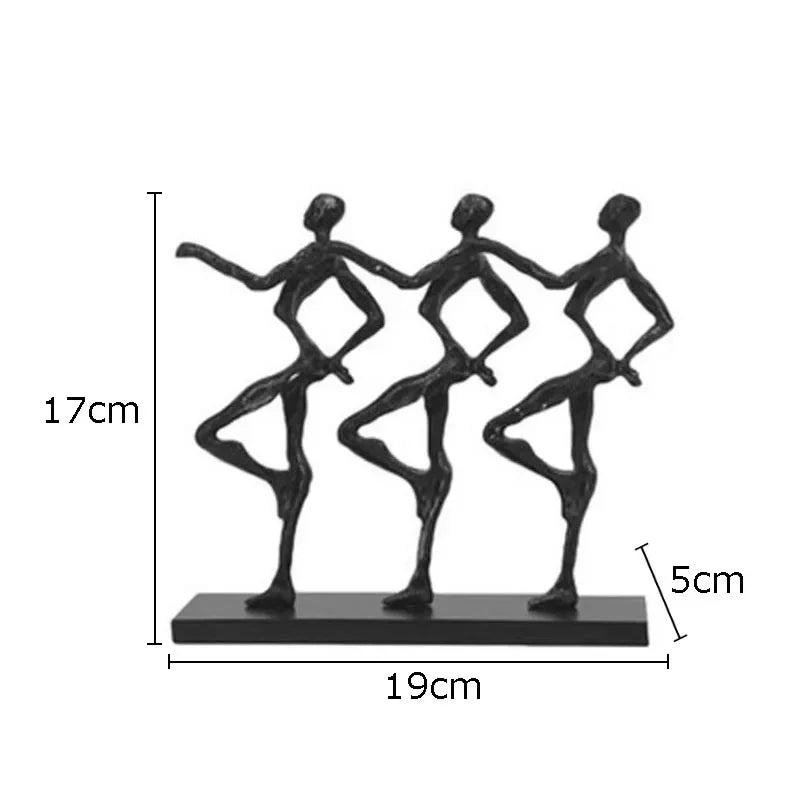 Black metallic unique metal sculpture depicting three abstract dancers on a rectangular base for a unique metal desk