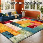 Colorful geometric-patterned rug in a living room with a blue sofa and orange walls.