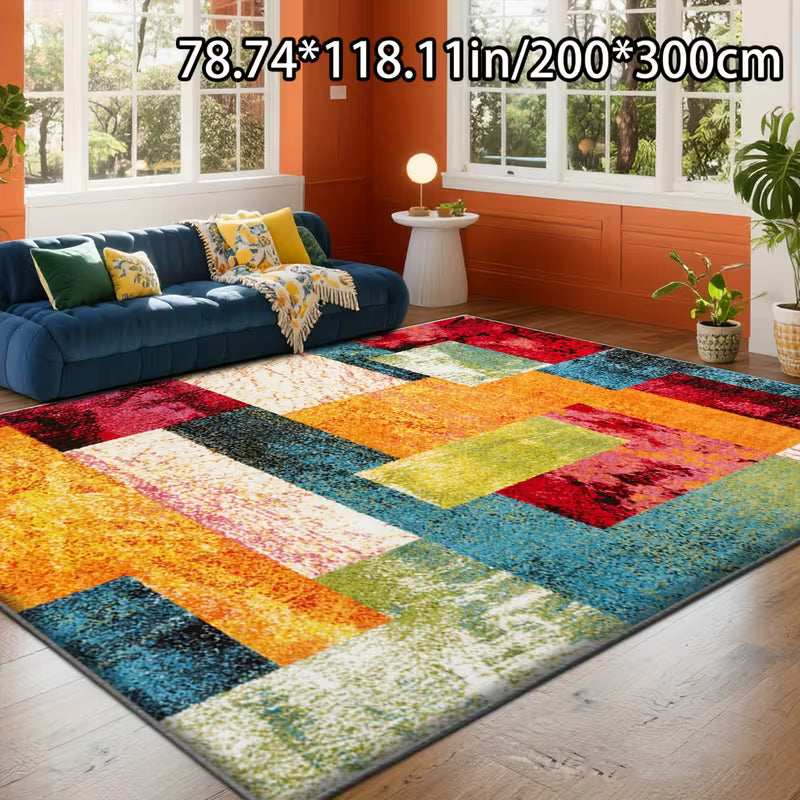 Colorful geometric-patterned rug in a living room with a blue sofa and orange walls.
