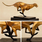 Modern running leopard sculpture features a golden metallic finish with black accents on a dark marble base for living rooms