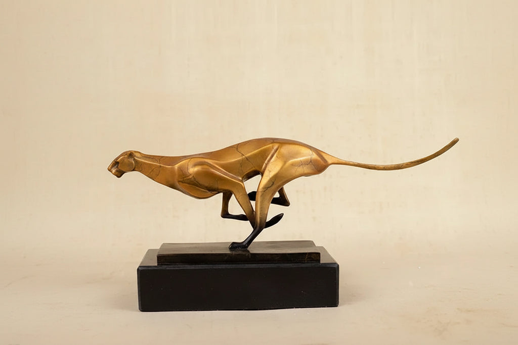 Golden cheetah sculpture with sleek design and polished metallic finish on black base for modern running leopard decor in living rooms