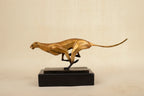 Golden cheetah sculpture with sleek design and polished metallic finish on black base for modern running leopard decor in living rooms