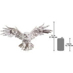 Detailed white owl sculpture with intricately carved feathers and outstretched wings made from decorative metal and high-quality materials