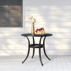 Black 23.6 inch round aluminum patio table with decorative lattice top and curved legs on a white porch.