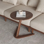 A sleek dark wood round wooden side table with a compact z-shaped base ideal as a living room coffee table