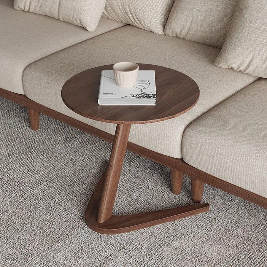 A sleek dark wood round wooden side table with a compact z-shaped base ideal as a living room coffee table