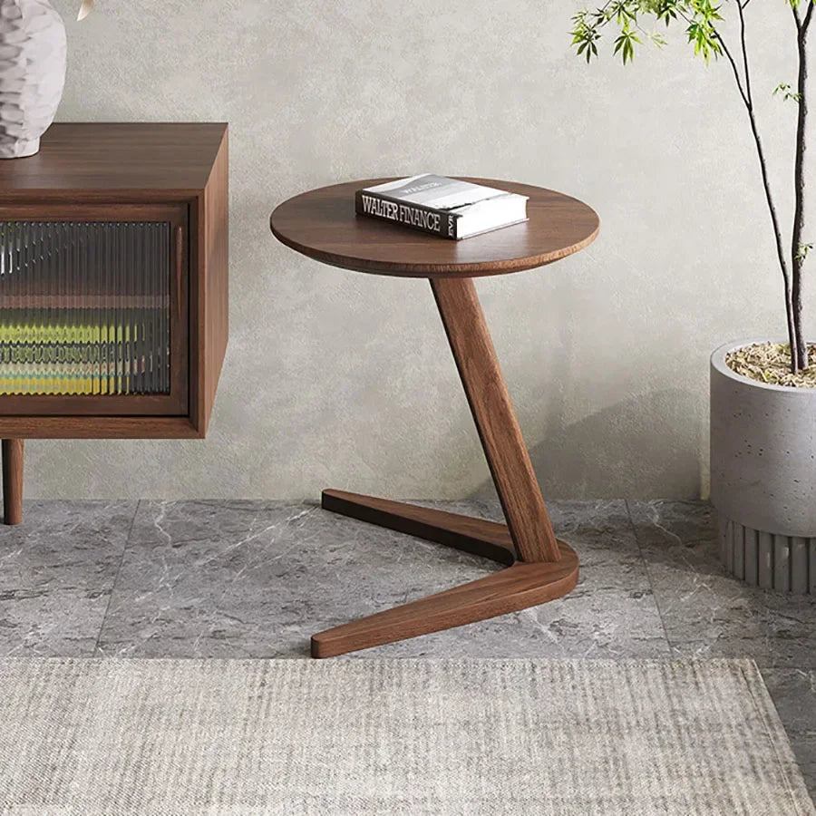 A sleek dark wood round wooden side table with a compact c-shape design ideal for small living room spaces