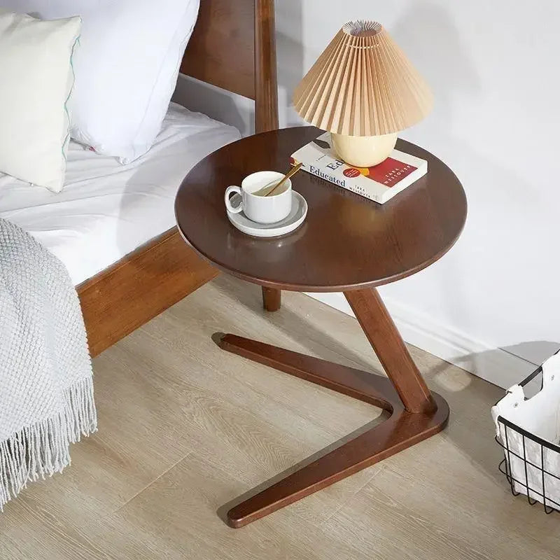 Dark brown compact wooden side table with round top and modern v-shaped base ideal for living room coffee table use