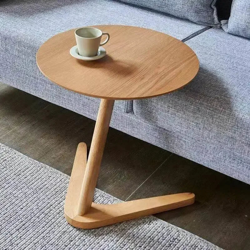 Light wood finished compact wooden coffee table with oval top and minimalist v shaped base for living room use