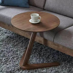 A sleek dark brown compact wooden side table with a modern z-shaped base ideal as a living room coffee table