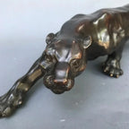 Bronze-colored running leopard bronze sculpture with detailed lifelike features and glossy finish for luxury decor