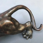 Bronze-colored running leopard bronze sculpture with sleek glossy finish and detailed paw for luxury home and office decor