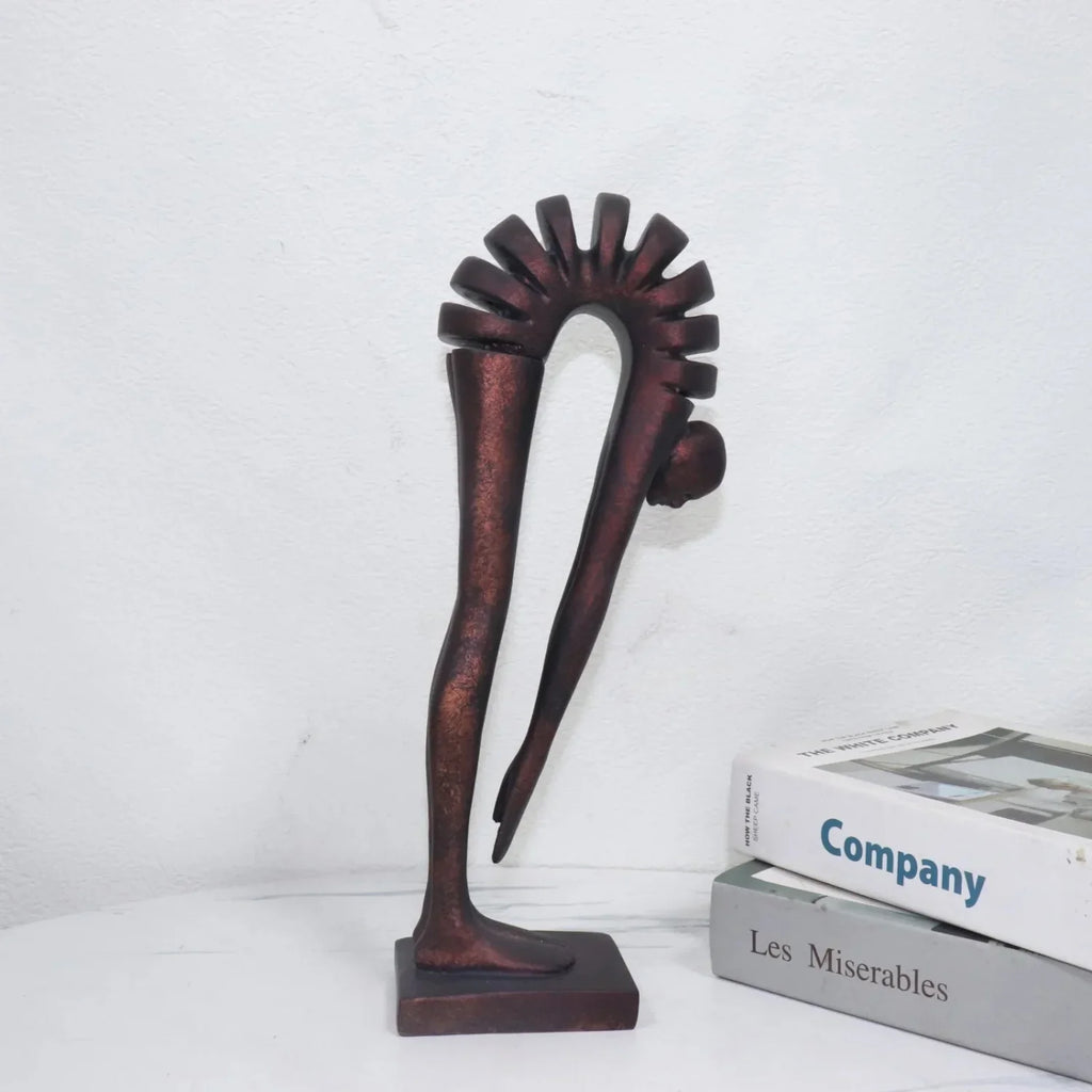 Decorative sculpture on a white surface with books in the background
