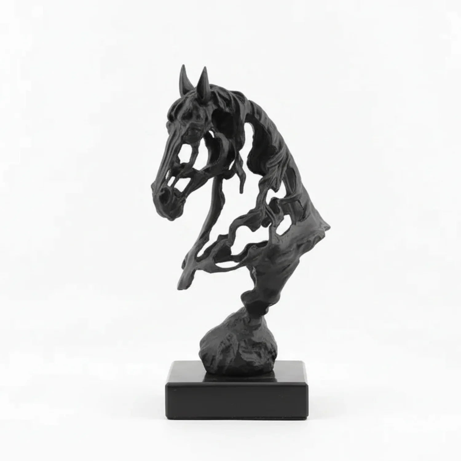 Black and gold horse sculptures on books with a gray background