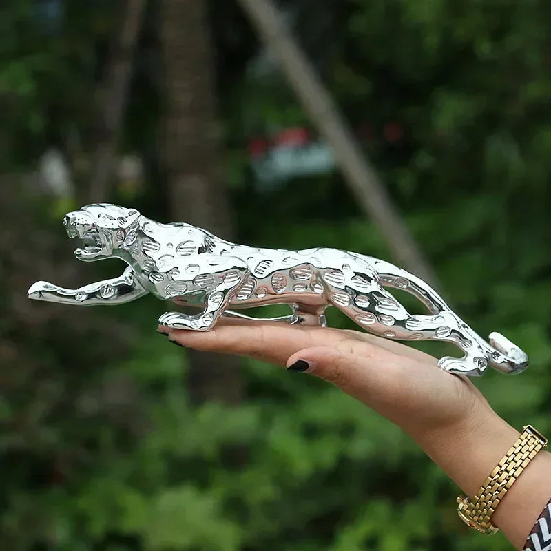 Silver leopard decorative tabletop sculpture featuring shiny silver metallic jaguar emblem with detailed spotted pattern
