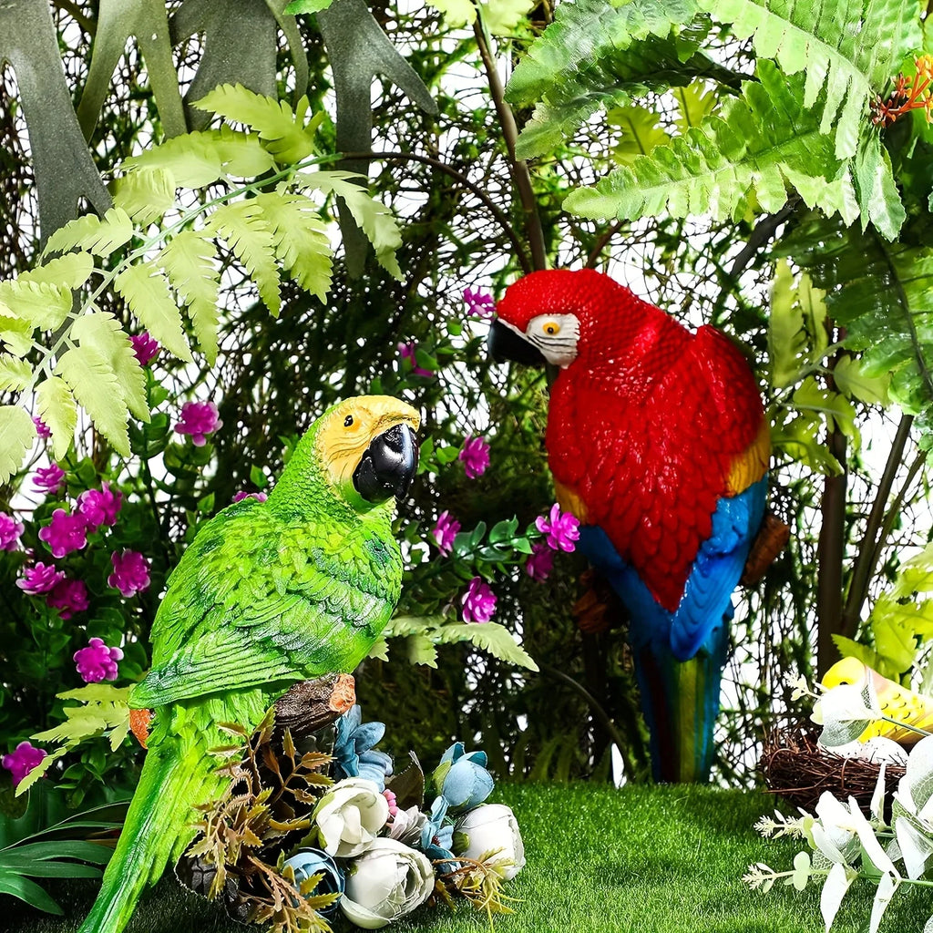 Two colorful 12-inch simulation parrots perched in a lush garden setting.