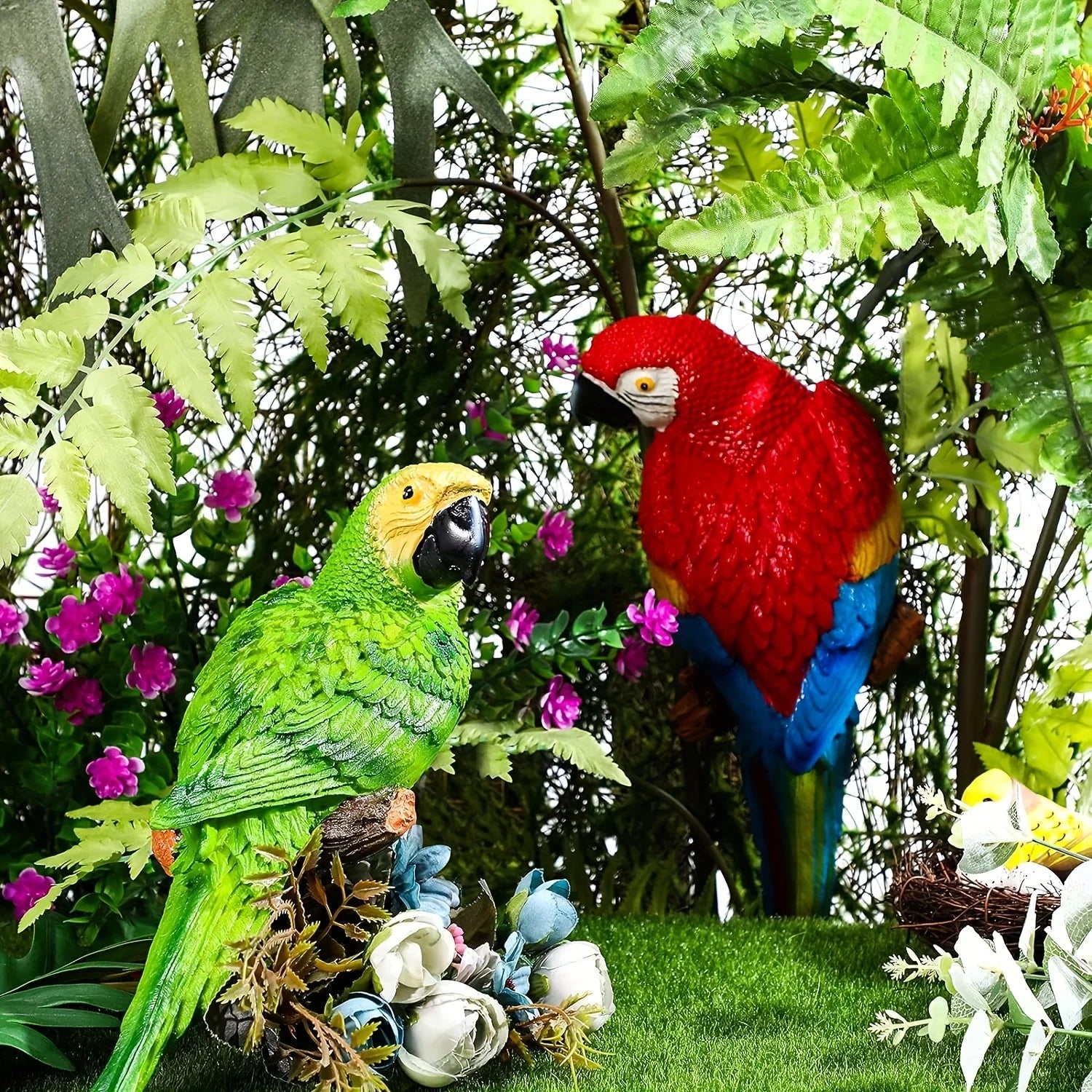Two colorful 12-inch simulation parrots perched in a lush garden setting.