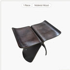 Dark brown solid wood small stool ottoman with sleek curved design and polished surfaces for apartment living spaces
