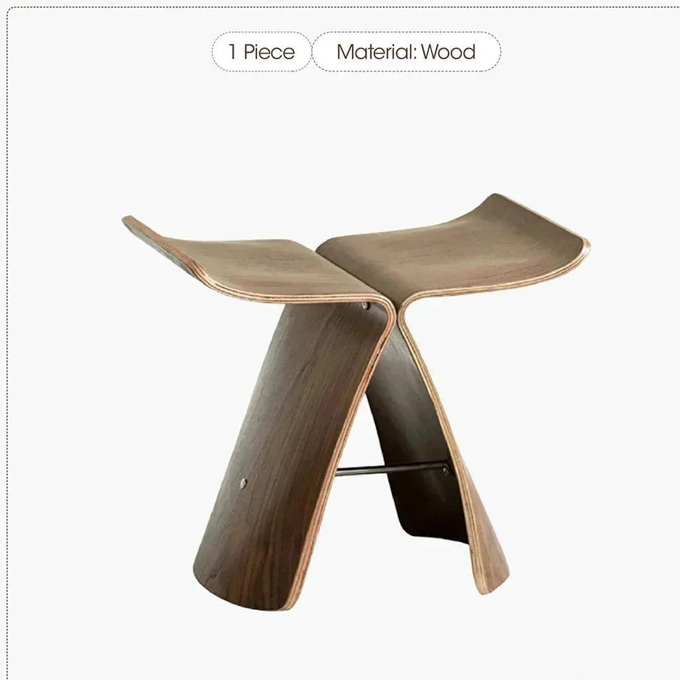 A sleek small stool ottoman made of solid wood with a curved design and dark brown finish for apartment living spaces