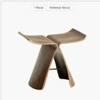 A sleek small stool ottoman made of solid wood with a curved design and dark brown finish for apartment living spaces