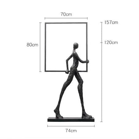 Black matte-finished abstract human figure sculpture holding a square frame for living room home decor