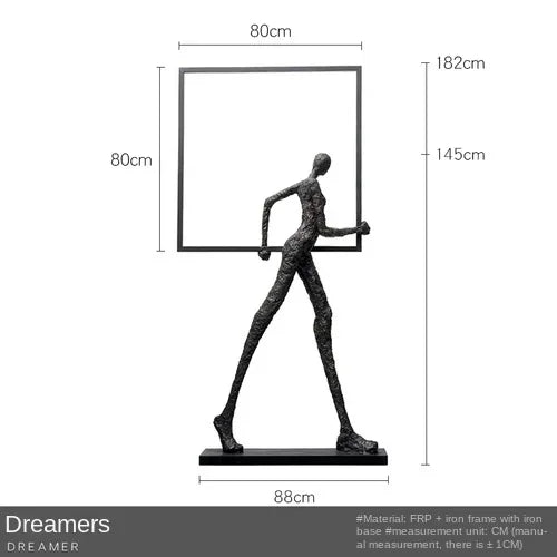 Black textured figurine holding a square frame on iron base accent for living room home decor with sofa cushion comfort