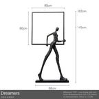 Black textured figurine holding a square frame on iron base accent for living room home decor with sofa cushion comfort
