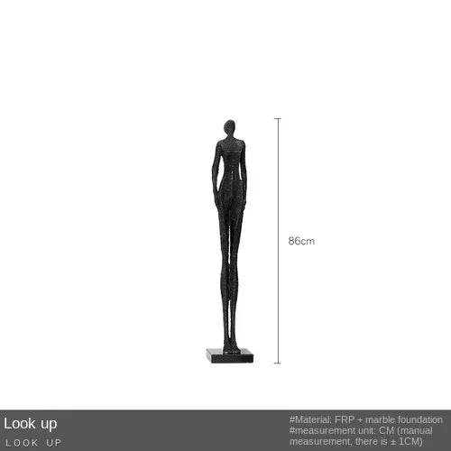 Black abstract human figure sculpture with textured surface featured as home decor near sofa cushion for living room