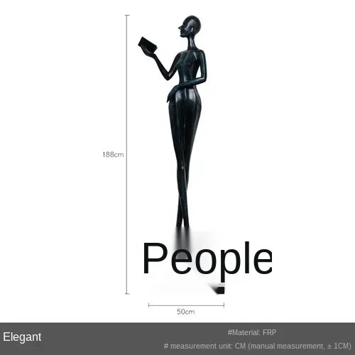 Black frp figurine of a slender woman holding a book paired with a comforting velvet large sofa cushion for living room decor