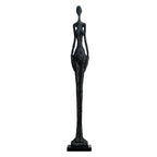 Black textured sculpture of a slender female figure on a black base complementing living room home decor
