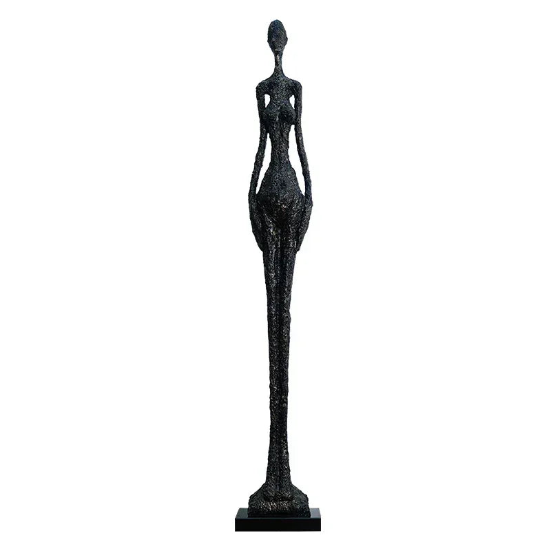 Black textured sculpture of a slender female figure on a black base complementing living room home decor