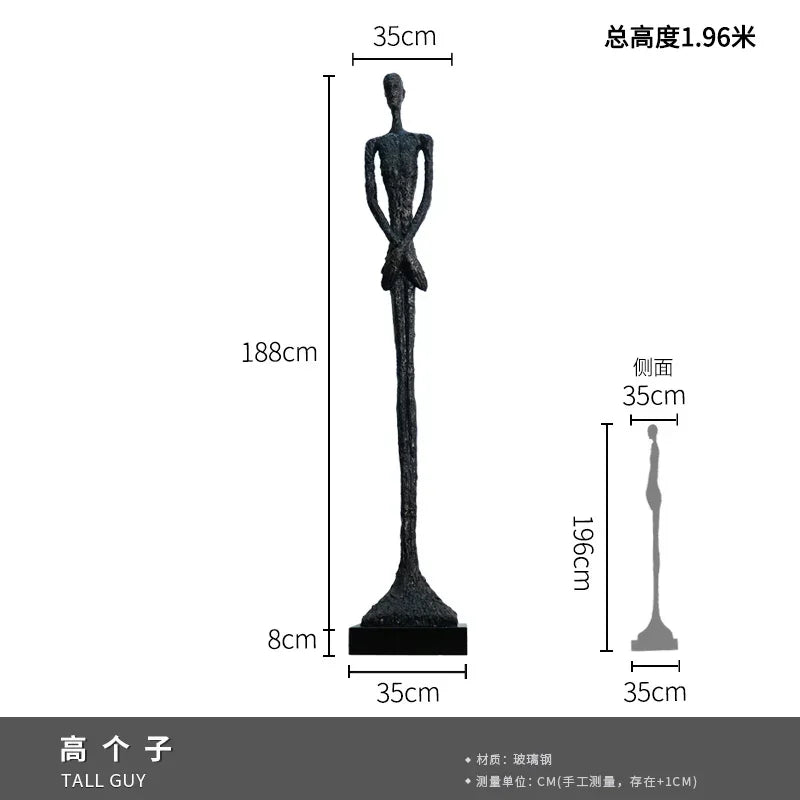 Black glass steel sculpture of tall slender figure with elongated limbs as elegant home decor in living room setting