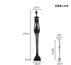 Black slender figurine sculpture with elongated limbs and minimalist design enhances living room home decor